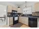 Traditional style kitchen featuring black appliances, light wood cabinets and decorative tile backsplash at 5710 Dapple Trce, Indianapolis, IN 46228