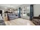 Open concept living room with hardwood floors, gray walls, large window, and furniture at 5710 Dapple Trce, Indianapolis, IN 46228