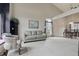 Open-concept living room with vaulted ceiling, neutral carpeting, and large windows that bring in ample natural light at 5710 Dapple Trce, Indianapolis, IN 46228