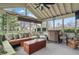 Cozy sunroom featuring comfortable seating, a ceiling fan, and serene views of the backyard at 5710 Dapple Trce, Indianapolis, IN 46228