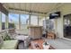 Relaxing sunroom with plush seating, wicker accents, and picturesque views of the outdoor space at 5710 Dapple Trce, Indianapolis, IN 46228