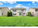 Large backyard features a lush lawn, mature trees, and a patio seating area at 5861 W Deerview Bnd, McCordsville, IN 46055