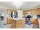 Light-filled kitchen featuring wood cabinetry, a central island, and updated stainless steel appliances at 5861 W Deerview Bnd, McCordsville, IN 46055