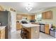 Bright kitchen with light wood cabinets, an island, and stainless steel appliances at 5861 W Deerview Bnd, McCordsville, IN 46055