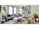 Cozy living room with a grey sofa, eclectic decor, and natural light from the patterned curtains at 5861 W Deerview Bnd, McCordsville, IN 46055