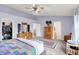 Serene main bedroom with a beautiful bed, patterned quilt, dresser, walk-in closet, and private bathroom at 5861 W Deerview Bnd, McCordsville, IN 46055