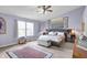 Inviting main bedroom with lavender walls, carpeted floors, and plenty of natural light for a calm retreat at 5861 W Deerview Bnd, McCordsville, IN 46055