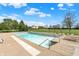 Community pool surrounded by lounge chairs and trees, perfect for relaxation at 5861 W Deerview Bnd, McCordsville, IN 46055