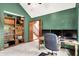 Home office featuring green walls, built-in shelves, and a staircase at 5861 W Deerview Bnd, McCordsville, IN 46055