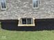 Basement window with safety features and fresh landscaping at 6089 W Hellis Dr, Muncie, IN 47304
