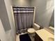 Bathroom featuring a toilet, shower curtain, wood vanity, and light colored walls at 6089 W Hellis Dr, Muncie, IN 47304