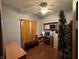 This bedroom has a ceiling fan with attached lighting, a desk, and a red and black office chair at 6089 W Hellis Dr, Muncie, IN 47304