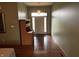 Inviting entryway showcasing hardwood floors and a classic wooden accent piece at 6089 W Hellis Dr, Muncie, IN 47304