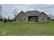 Classic brick house with a well-maintained lawn and a basketball hoop at 6089 W Hellis Dr, Muncie, IN 47304