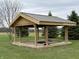 Outdoor fire pit area with wood frame surrounded by trees, perfect for entertaining on cool nights at 6089 W Hellis Dr, Muncie, IN 47304