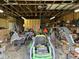 Garage is cluttered with tools and equipment, providing ample storage and workspace at 6089 W Hellis Dr, Muncie, IN 47304