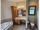 Well-appointed main bathroom featuring double sinks and a separate tub at 6089 W Hellis Dr, Muncie, IN 47304