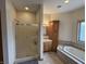 Luxurious bathroom featuring a glass shower and soaking tub at 6089 W Hellis Dr, Muncie, IN 47304