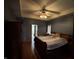 This spacious main bedroom features a tray ceiling with a fan, wood floors, and an attached bathroom at 6089 W Hellis Dr, Muncie, IN 47304