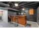 Finished basement features a custom wooden bar and barstool seating, perfect for entertaining at 6120 Norwaldo Ave, Indianapolis, IN 46220