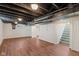 Spacious finished basement with new flooring, exposed ceiling, and a staircase leading to the main level at 6120 Norwaldo Ave, Indianapolis, IN 46220