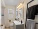 Well-lit bathroom with a modern vanity, updated fixtures, and a shower-tub combo at 6120 Norwaldo Ave, Indianapolis, IN 46220