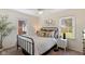 Charming bedroom with a metal bed frame, neutral decor, and bright natural light at 6120 Norwaldo Ave, Indianapolis, IN 46220