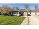 Charming stone home featuring a cozy screened-in porch and well-manicured lawn at 6120 Norwaldo Ave, Indianapolis, IN 46220