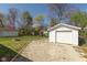 Single car detached garage with driveway and partial view of the backyard at 6120 Norwaldo Ave, Indianapolis, IN 46220