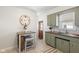 Efficient kitchen with wood countertops, olive cabinets and tile flooring at 6120 Norwaldo Ave, Indianapolis, IN 46220