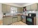 Charming kitchen with olive-green cabinets and stainless steel appliances at 6120 Norwaldo Ave, Indianapolis, IN 46220