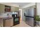 Well-equipped kitchen with stainless steel appliances, wood countertops and neutral tile flooring at 6120 Norwaldo Ave, Indianapolis, IN 46220