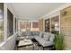 Relaxing screened porch with stone exterior, comfortable seating and neutral decor at 6120 Norwaldo Ave, Indianapolis, IN 46220