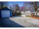 Backyard with garage, deck, lush lawn, and surrounding fence at 619 Kessler Blvd E Dr, Indianapolis, IN 46220