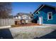 Backyard deck with outdoor dining area and blue house facade at 619 Kessler Blvd E Dr, Indianapolis, IN 46220