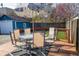 Enjoy outdoor living on this backyard deck with table, chairs, umbrella, and string lights at 619 Kessler Blvd E Dr, Indianapolis, IN 46220