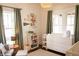 Bright Bedroom featuring hardwood floors, natural light, and stylish decor at 619 Kessler Blvd E Dr, Indianapolis, IN 46220