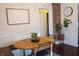 Cozy dining area featuring a wooden table, brick accent wall, and neutral decor at 619 Kessler Blvd E Dr, Indianapolis, IN 46220