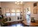 Sunlit dining area with built-in cabinetry, a wooden table, and modern lighting at 619 Kessler Blvd E Dr, Indianapolis, IN 46220