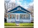 Charming bungalow with blue and white exterior, featuring a well-manicured lawn and inviting curb appeal at 619 Kessler Blvd E Dr, Indianapolis, IN 46220