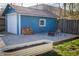 Backyard featuring garage, firewood storage, fire pit, lush lawn, and surrounding fence at 619 Kessler Blvd E Dr, Indianapolis, IN 46220