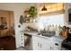Well-lit kitchen featuring stainless steel appliances, natural light, and open shelving at 619 Kessler Blvd E Dr, Indianapolis, IN 46220