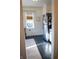 Compact kitchen with stainless steel refrigerator, dark floors, and modern lighting at 619 Kessler Blvd E Dr, Indianapolis, IN 46220