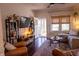 Open living room featuring hardwood floors, modern furniture, and natural light with view to sunroom at 619 Kessler Blvd E Dr, Indianapolis, IN 46220
