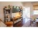 Comfortable living room with dark wood floors, stylish decor, and an open doorway to the sunroom at 619 Kessler Blvd E Dr, Indianapolis, IN 46220