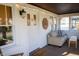 Inviting sunroom with a cushioned sofa, string lights, and bright windows providing natural light at 619 Kessler Blvd E Dr, Indianapolis, IN 46220