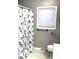 Cozy bathroom featuring a shower with floral curtain and a window offering natural light at 6431 W 800 S, Pendleton, IN 46064