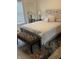 Comfortable bedroom features a queen-sized bed, patterned bench, and a large decorative mirror at 6431 W 800 S, Pendleton, IN 46064