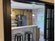 Inviting kitchen with breakfast bar and views, featuring wooden cabinets, stainless steel appliances, and modern lighting at 6431 W 800 S, Pendleton, IN 46064