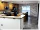 Charming kitchen featuring wooden cabinets, stainless steel appliances, and a breakfast bar with pendant lighting at 6431 W 800 S, Pendleton, IN 46064